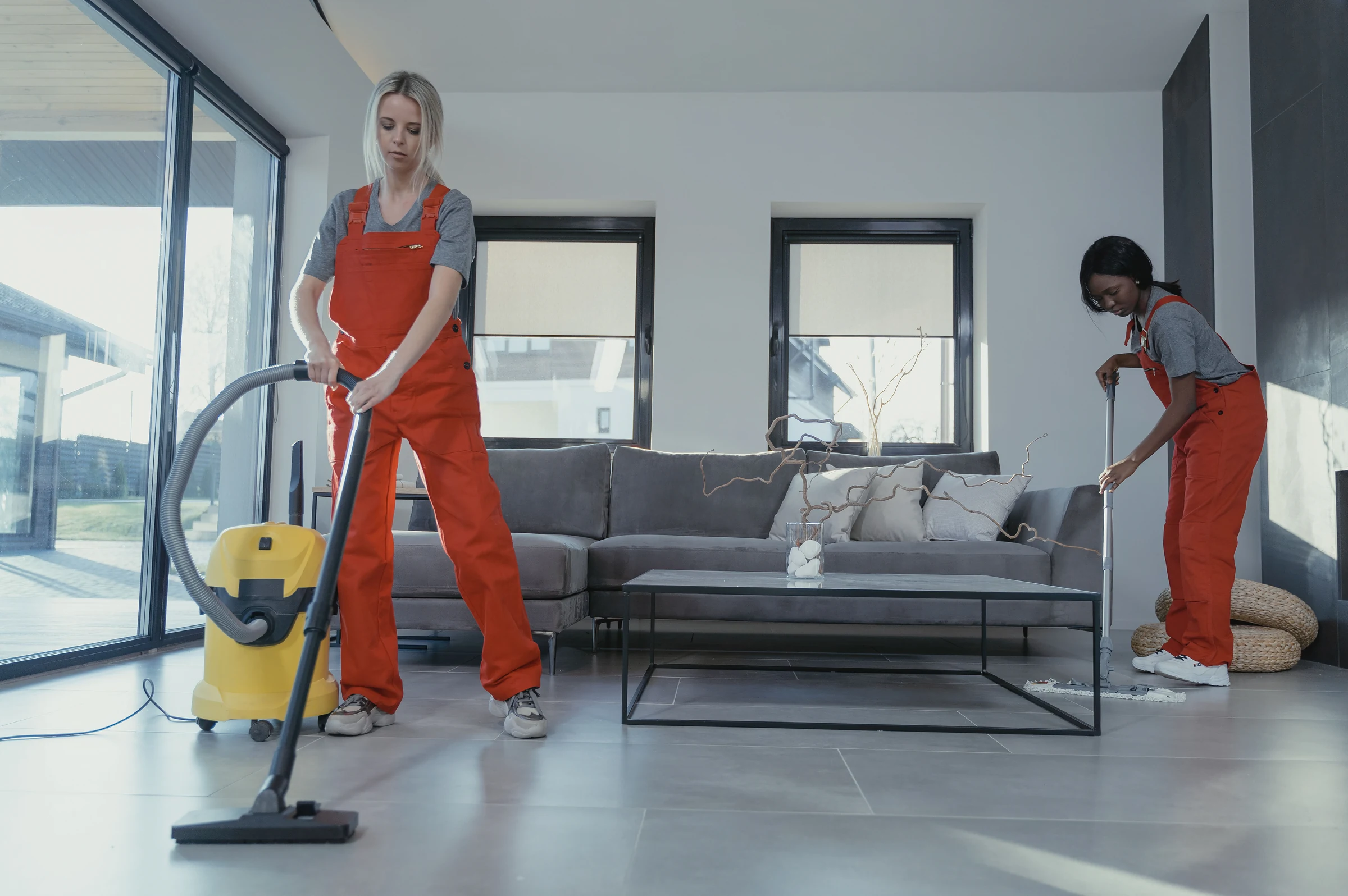 Bedrooms and living areas: a cleaner in overalls at work
